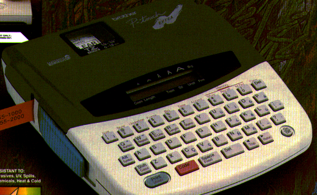 Brother P-touch PT-310B handheld electronic labeling system with QWERTY keyboard and compact LCD, cropped from the original Brother product brochure